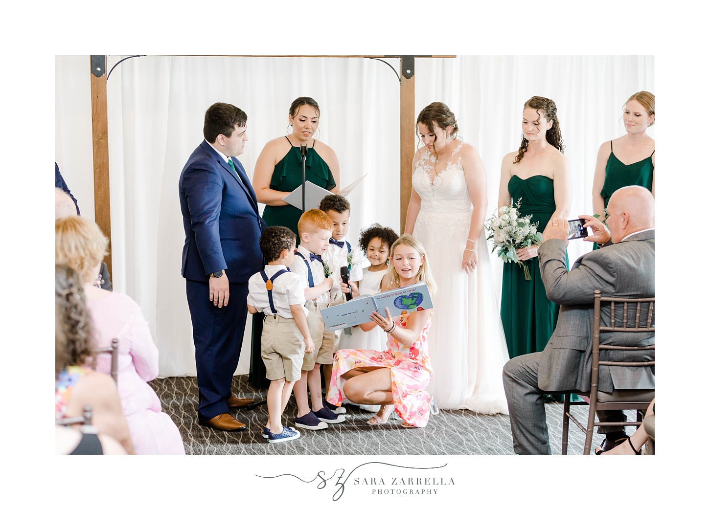 bride and groom listen to children read during wedding ceremony at Harbor Lights