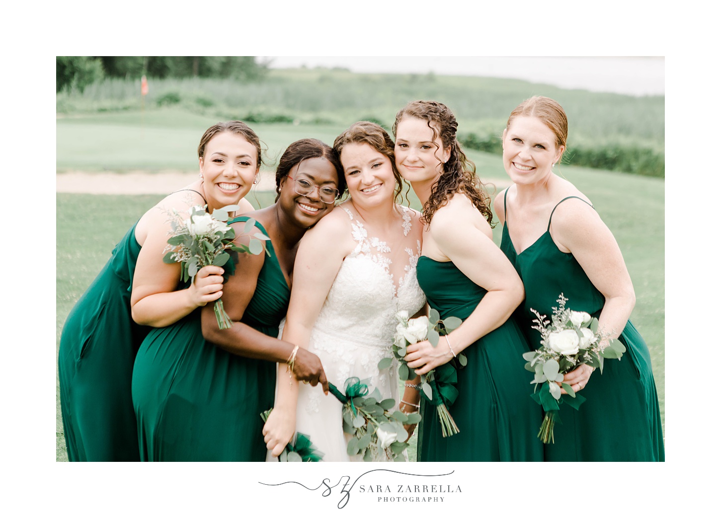 bride hugs bridesmaids tightly during Newport RI wedding day