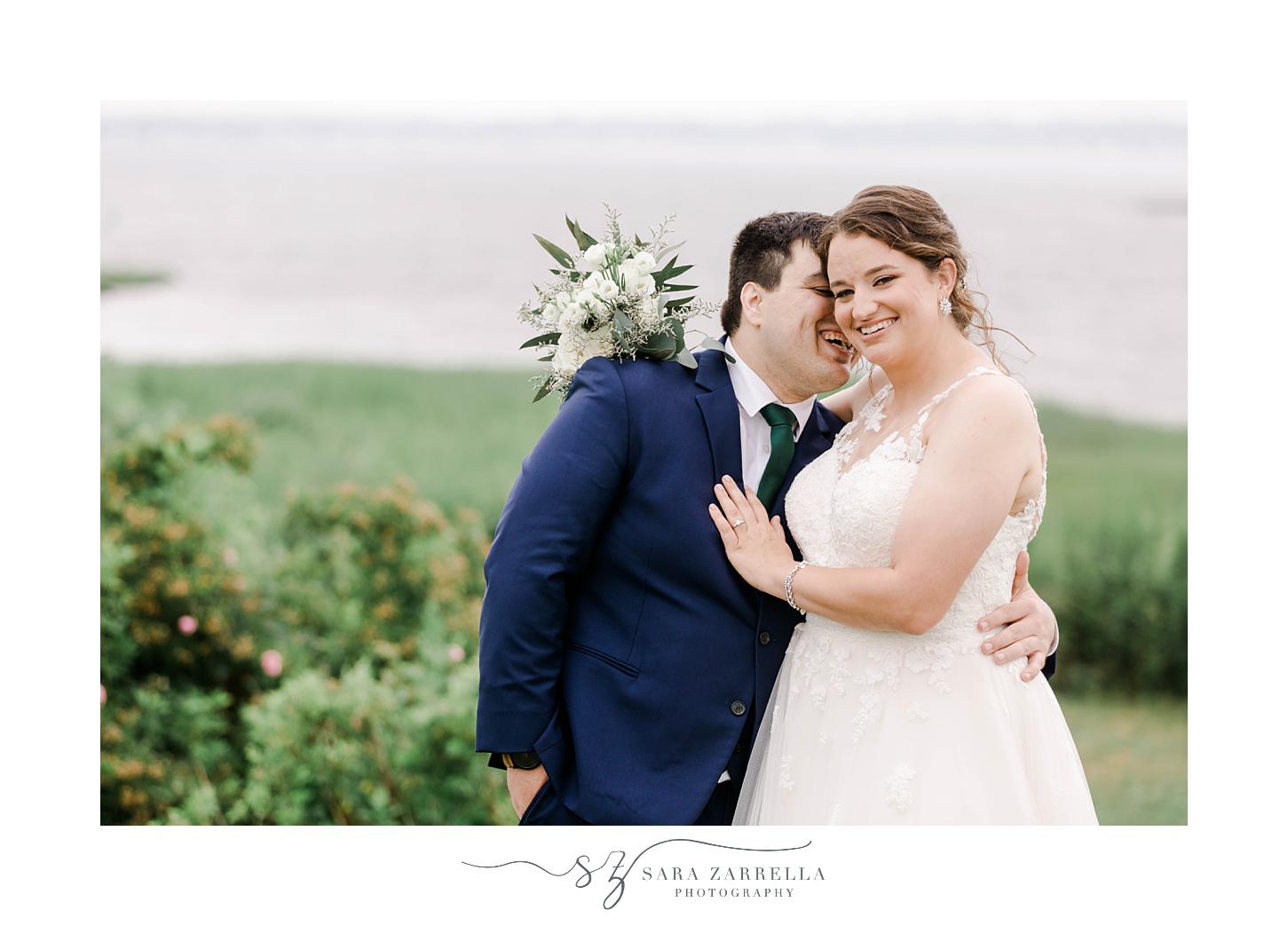 groom laughs hugging bride and whispering in her ear 