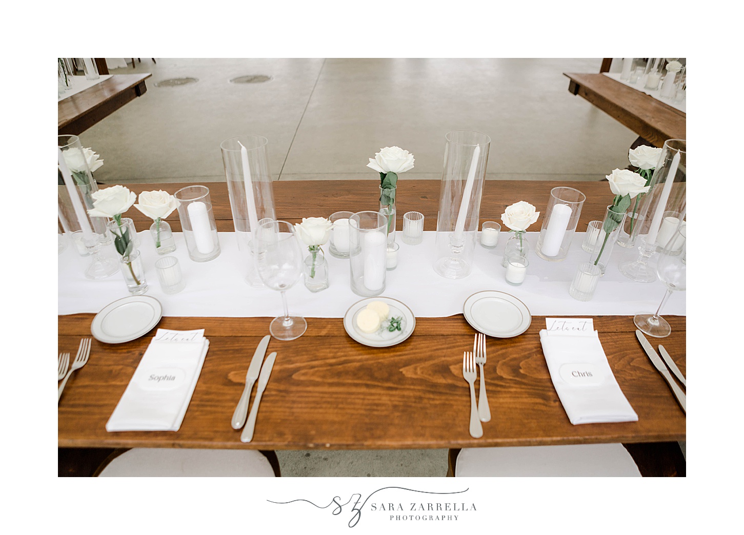 place setting for summer wedding with white candles and flowers 