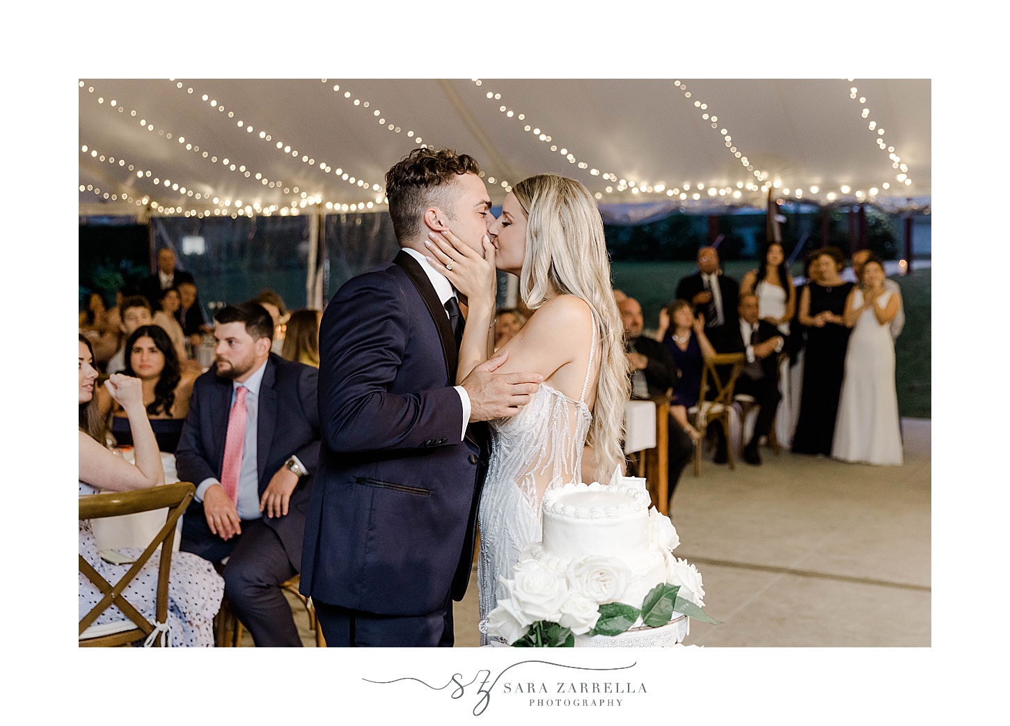 bride and groom kiss after cake cutting during RI wedding reception 