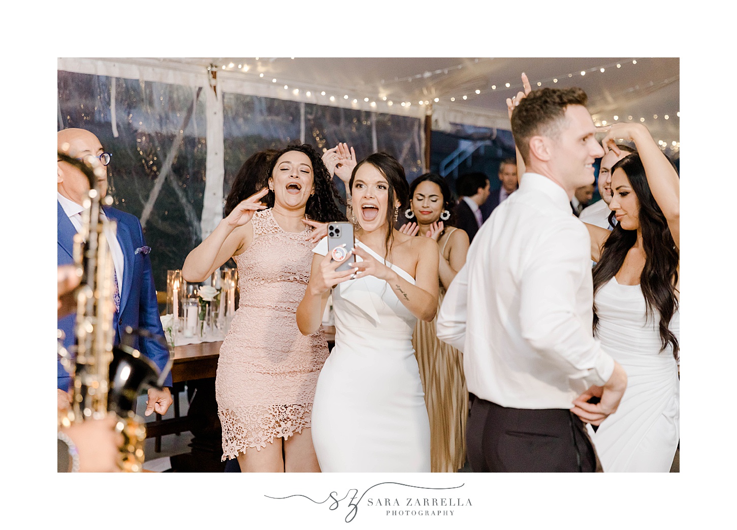 guests dance during wedding reception under tent at Shepard's Run