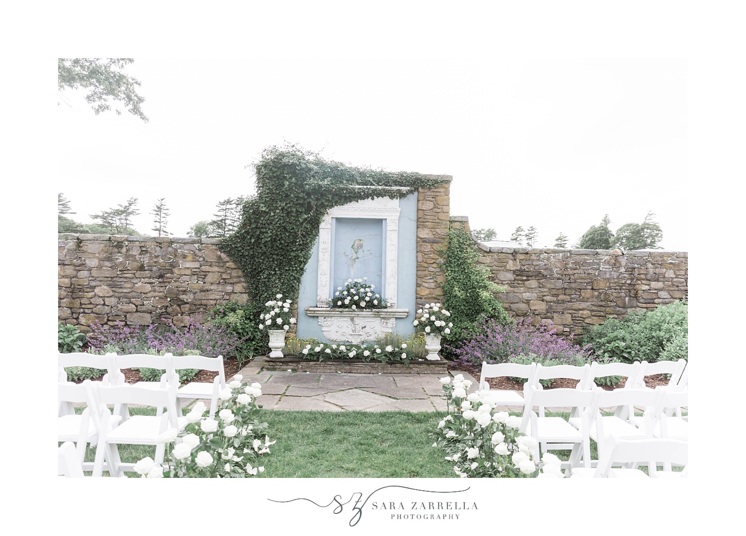 wedding ceremony setup in garden at Shepard's Run with white flowers and white chairs 