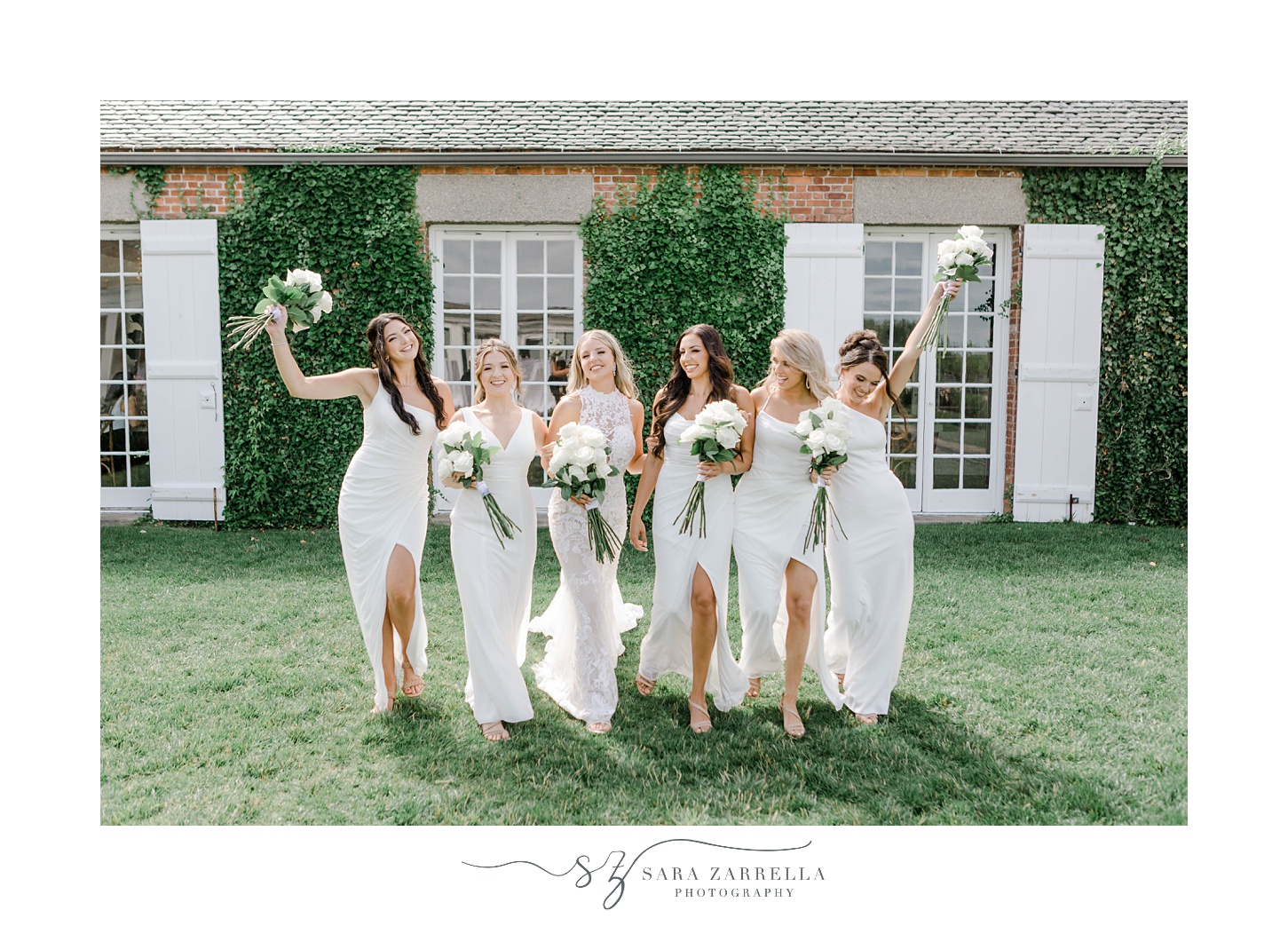 bride and bridesmaids in white gowns hold up bouquets 