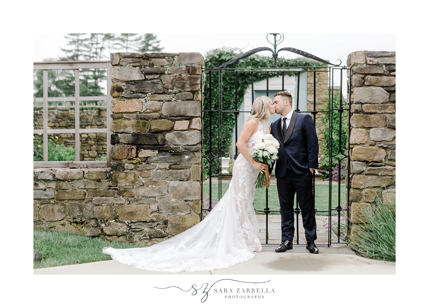 bride and groom kiss near wrought iron fence at Shepard's Run