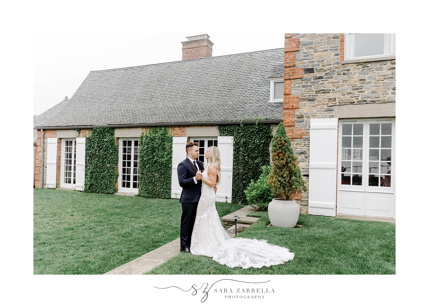 newlyweds hug in front of little house on property at Shepard's Run