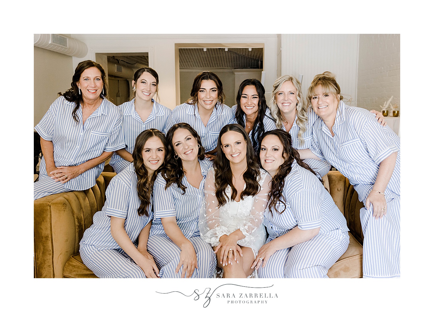 bride poses with bridesmaids in matching blue robes 