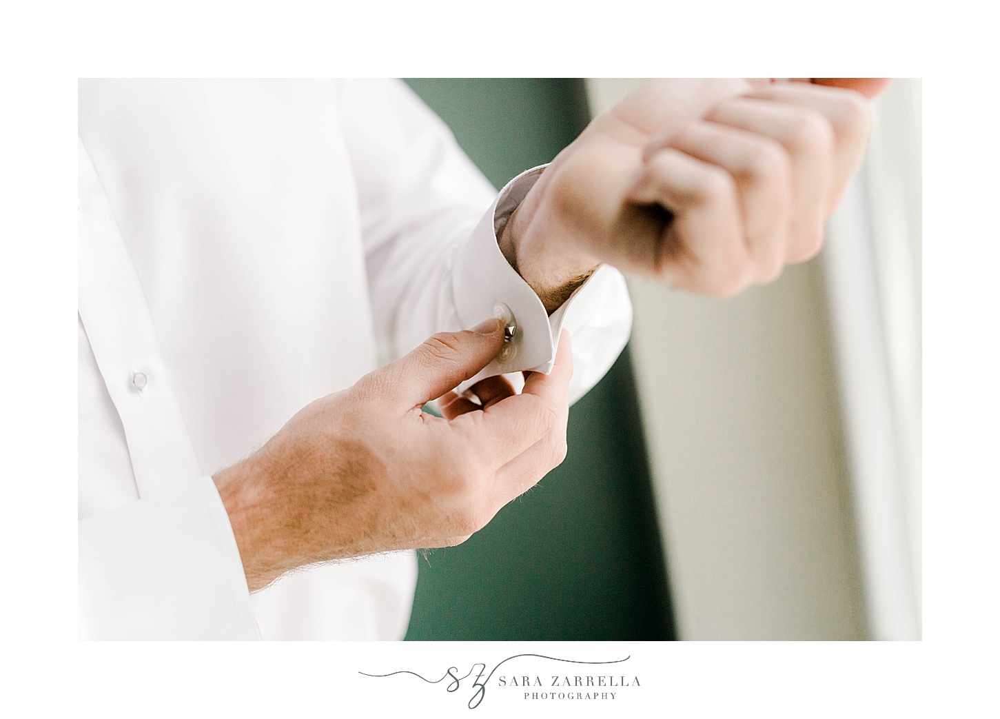 groom adjusts cufflinks before RI wedding 