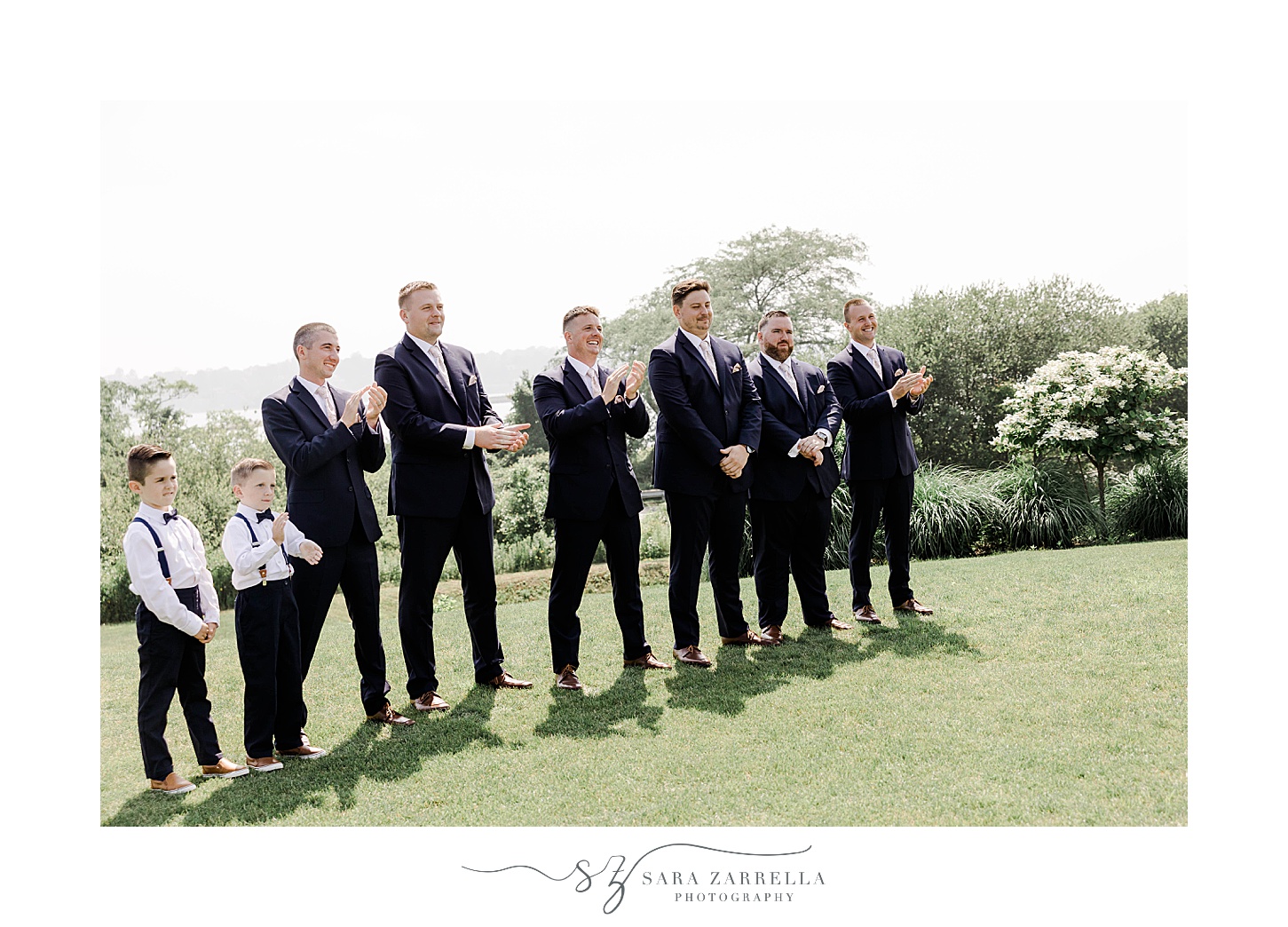 groomsmen watch first look on lawn at v