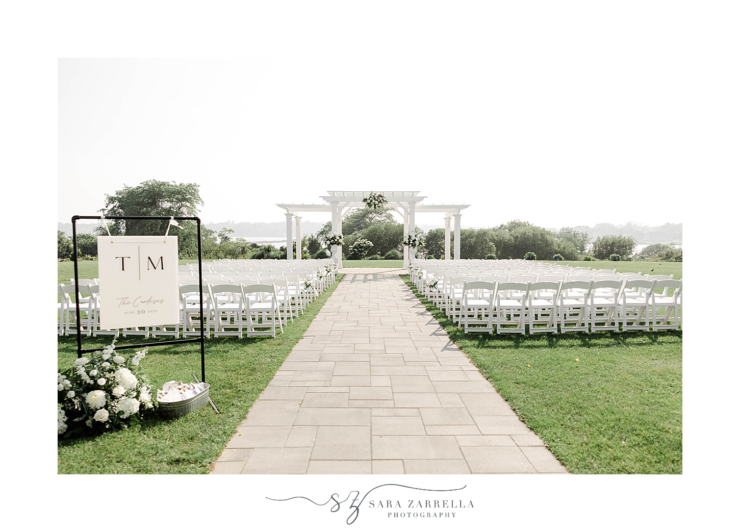 wedding ceremony setup with white chairs and arbor on lawn at the Wyndham Newport Hotel