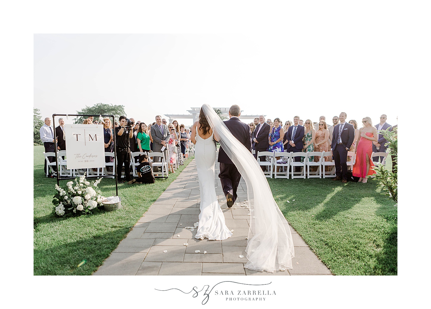 bride walks down aisle with father at the Wyndham Newport Hotel
