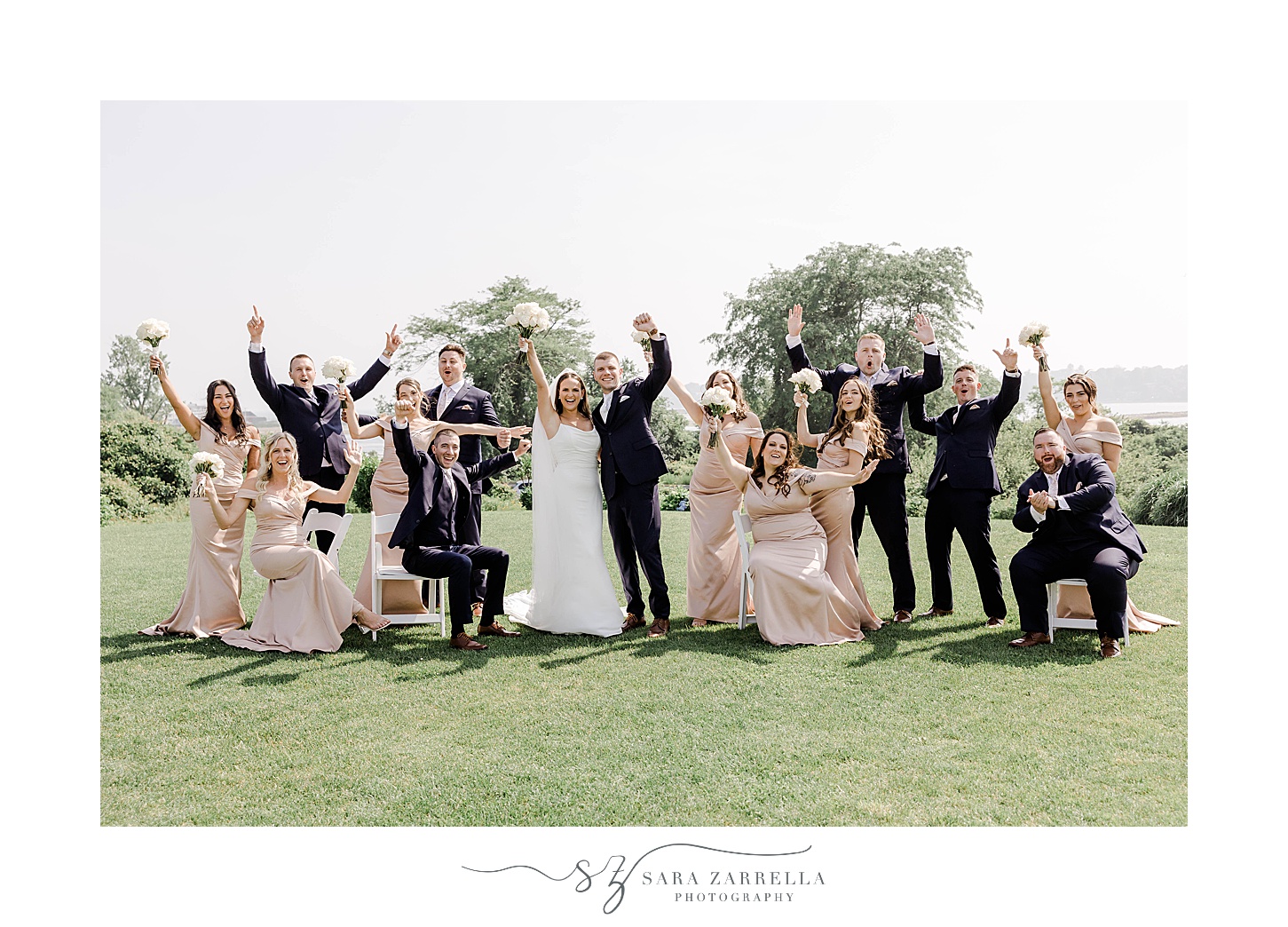 newlyweds cheer with wedding party on lawn at the Wyndham Newport Hotel