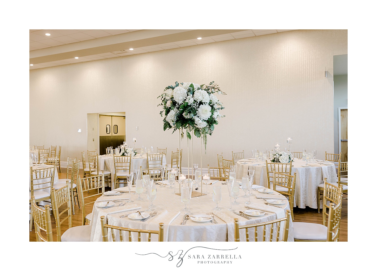 tall centerpiece with white and green flowers 