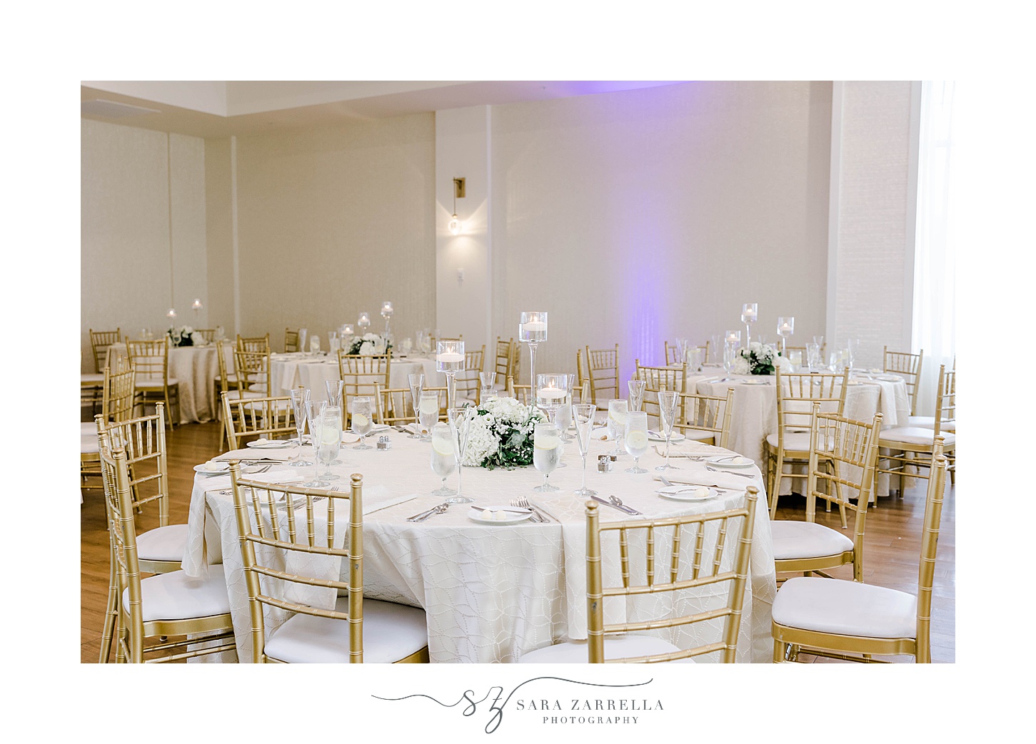 wedding reception tables with white cloth and gold chivari chairs t the Wyndham Newport Hotel