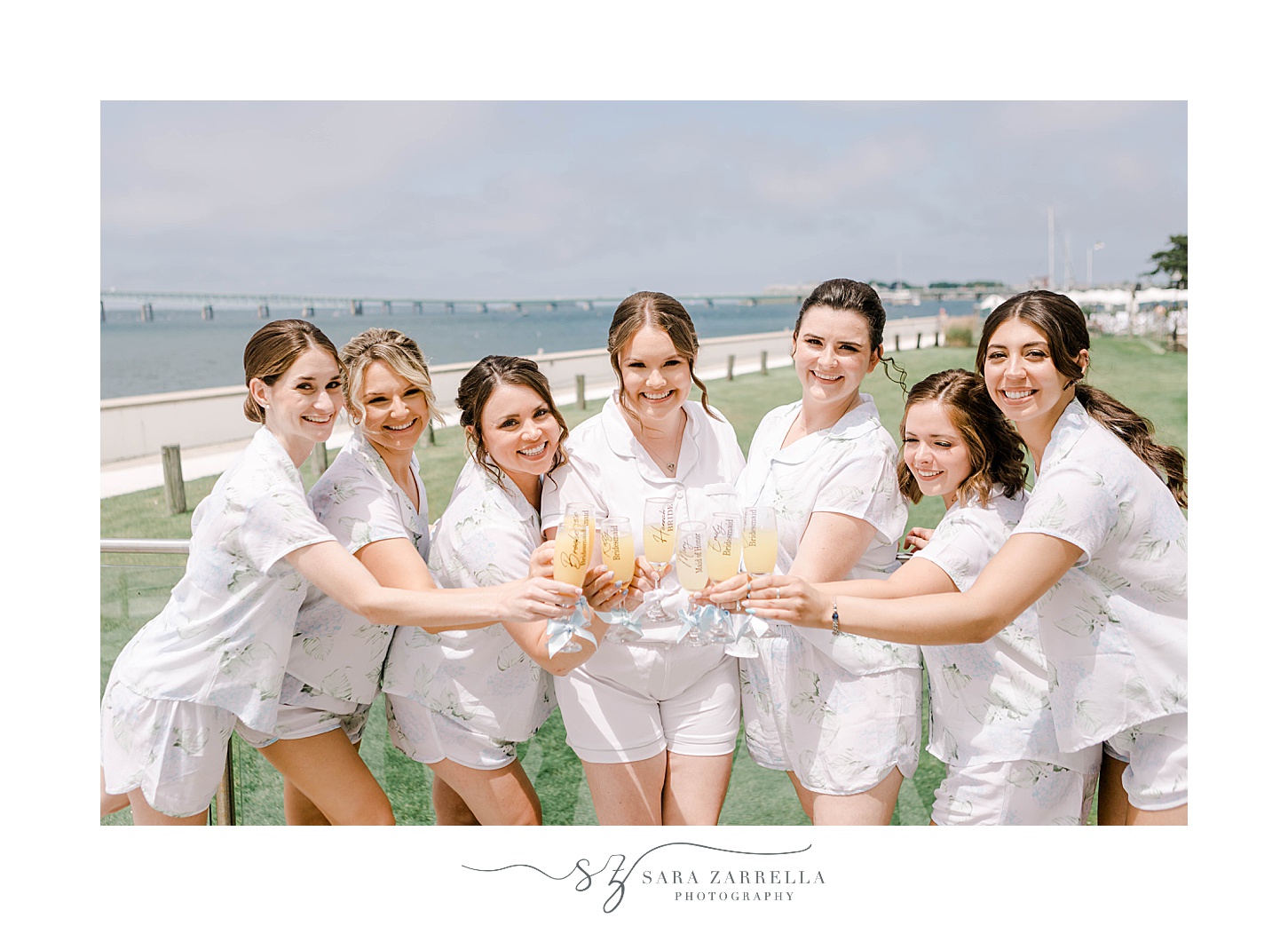 bride and bridesmaids toast champagne on patio at Newport Harbor Island Resort