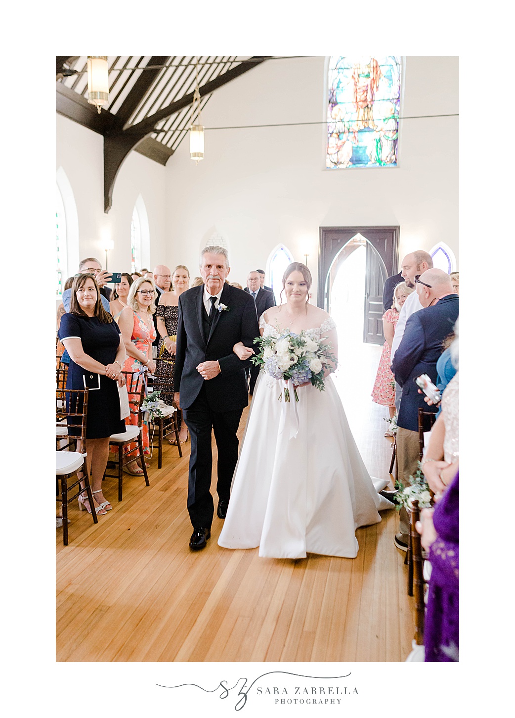 bride and father walk down aisle for wedding ceremony at Kay Chapel in Newport RI