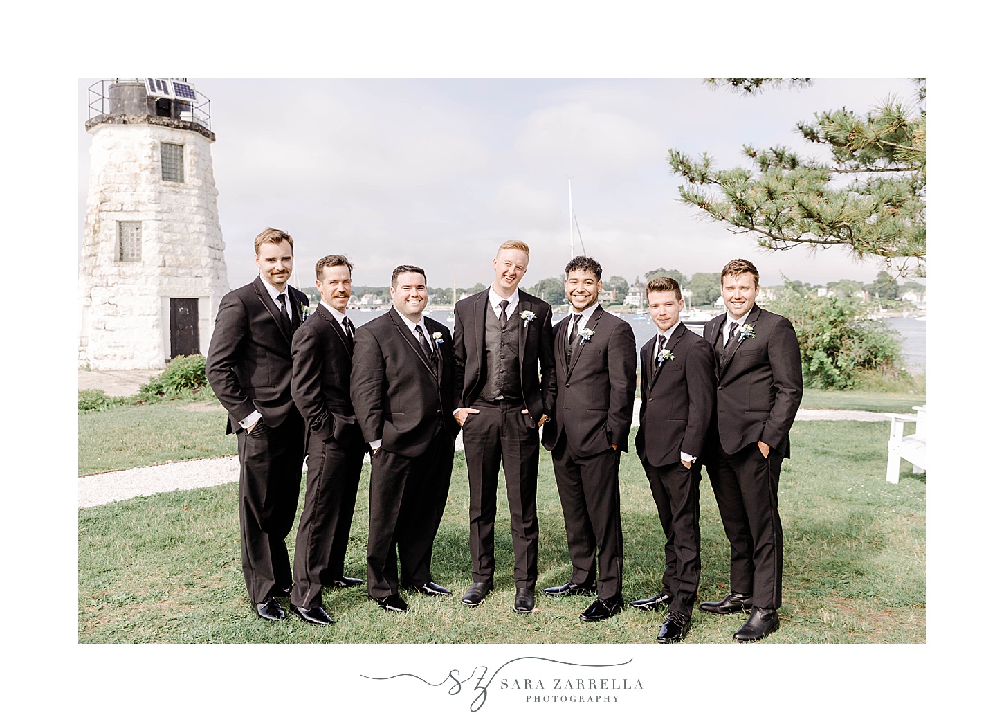 groom stand with groomsmen in black suits at Newport Harbor Island Resort