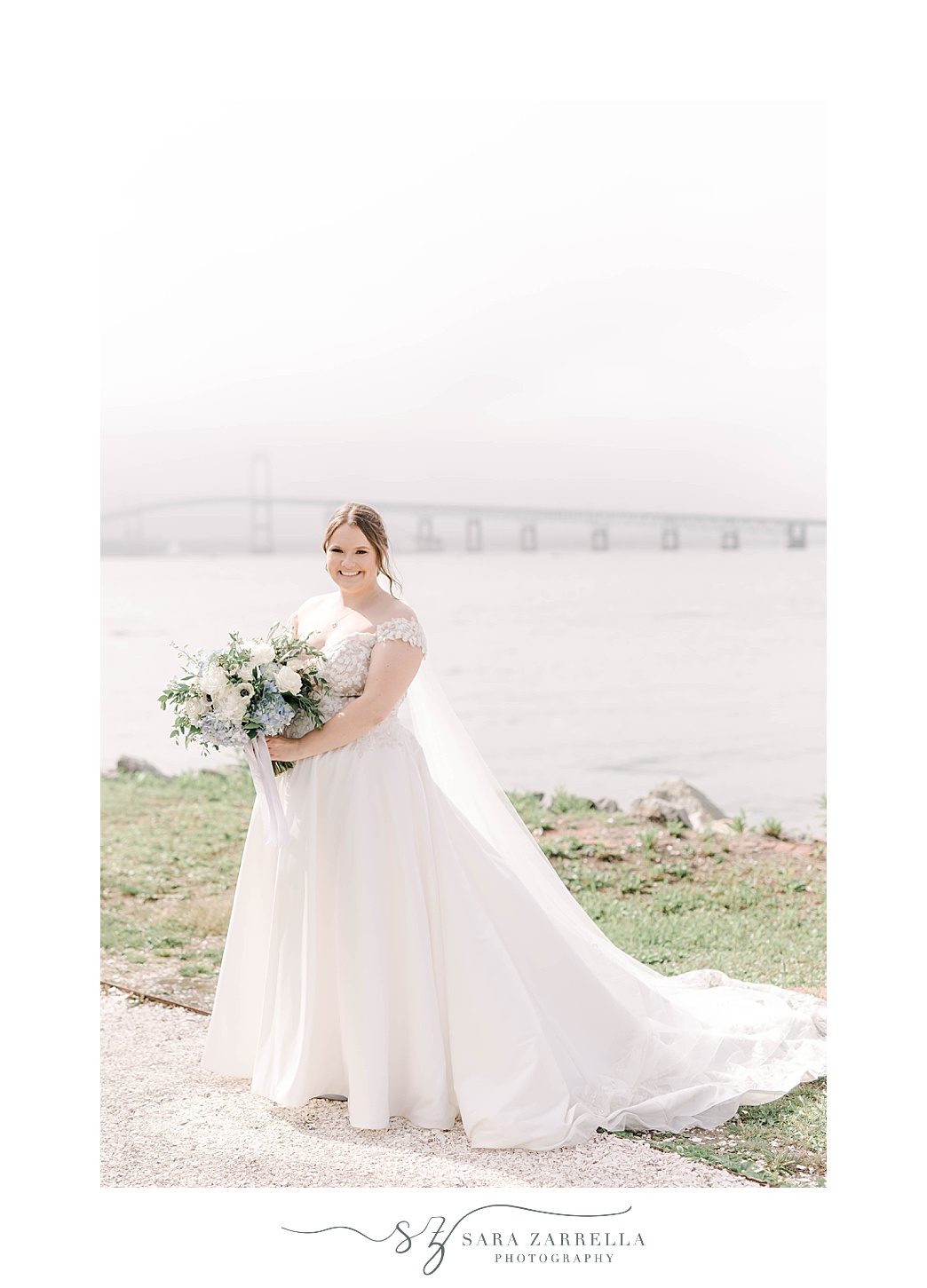 bride poses holding bouquet of white and blue flowers 