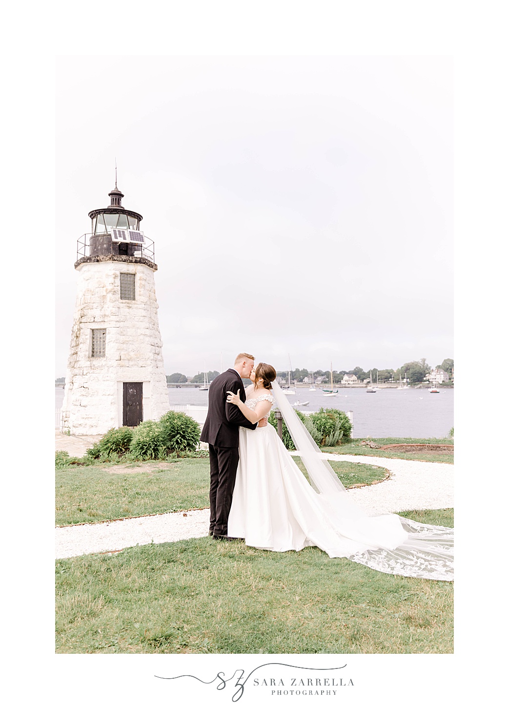 bride and groom kiss by Newport Lighthouse in Rhode Island 
