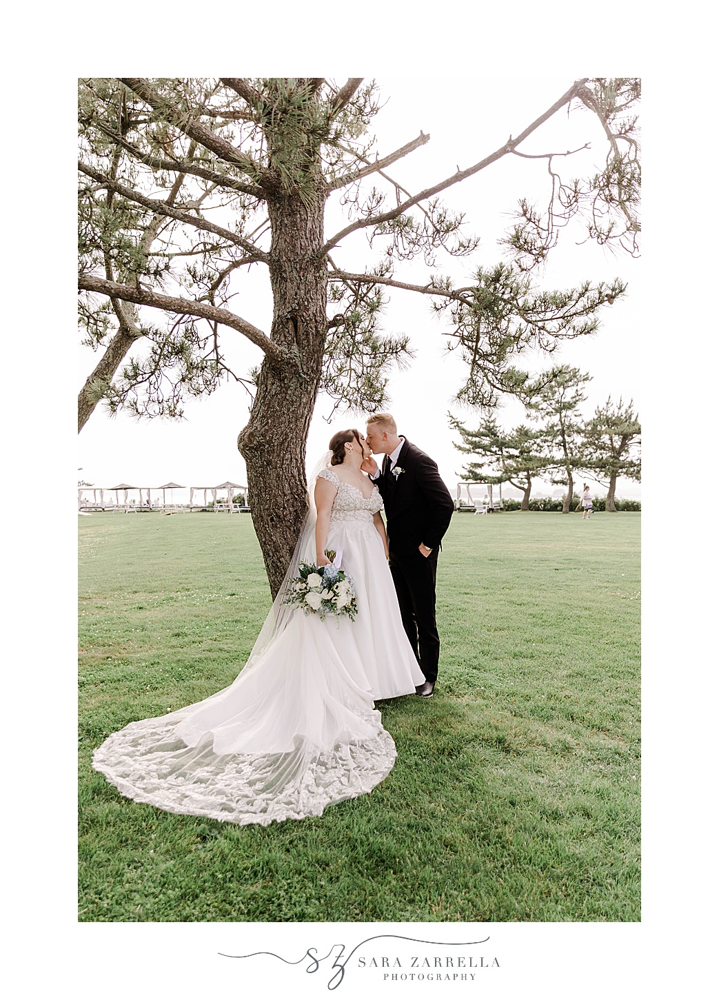 bride and groom kiss near tree at Newport Harbor Island Resort 