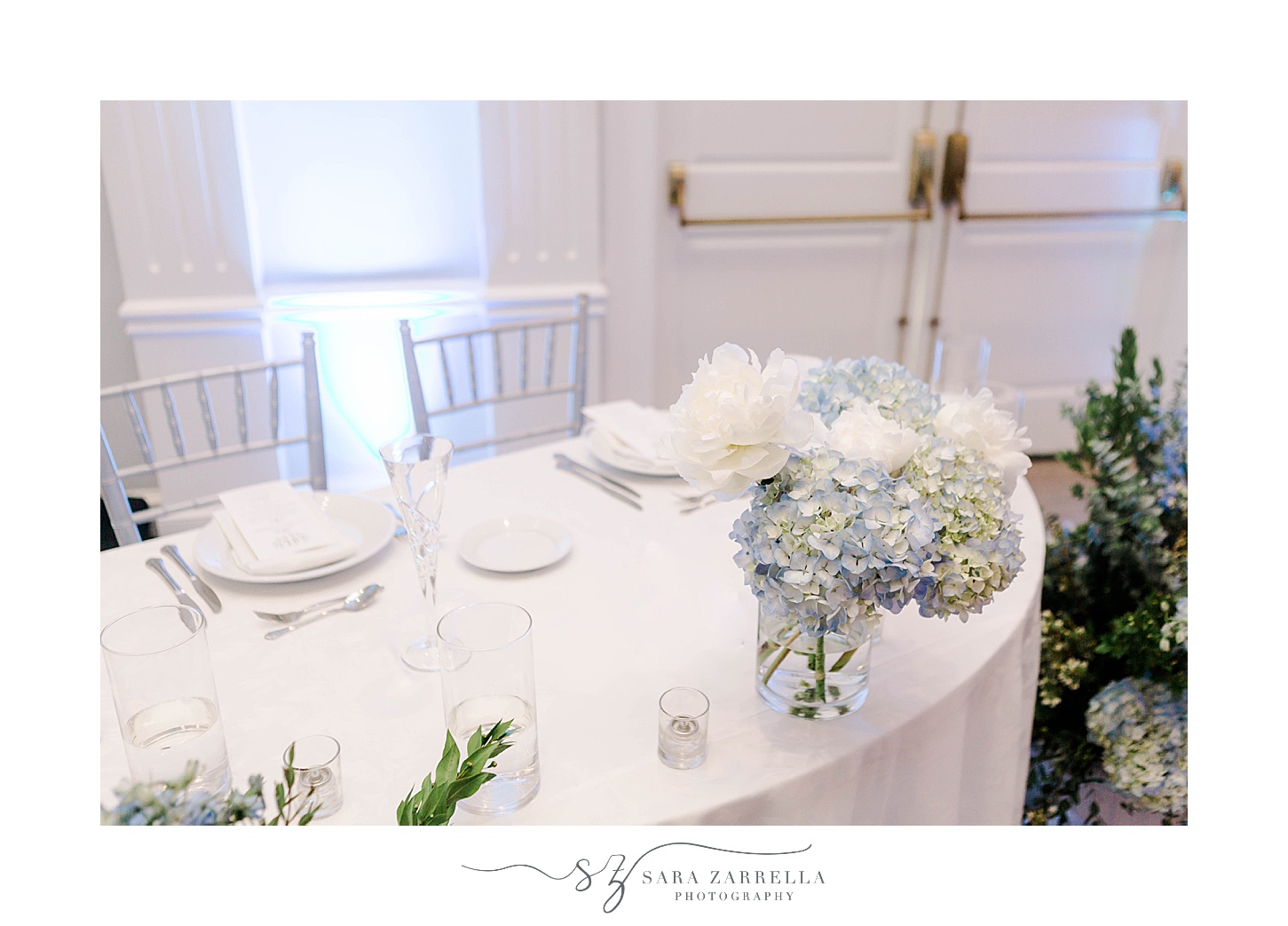 sweetheart table with white and blue flowers for coastal wedding reception at Newport Harbor Island Resort