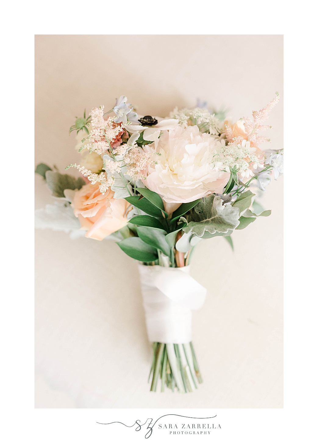 bride's bouquet of white, peach, and blue flowers