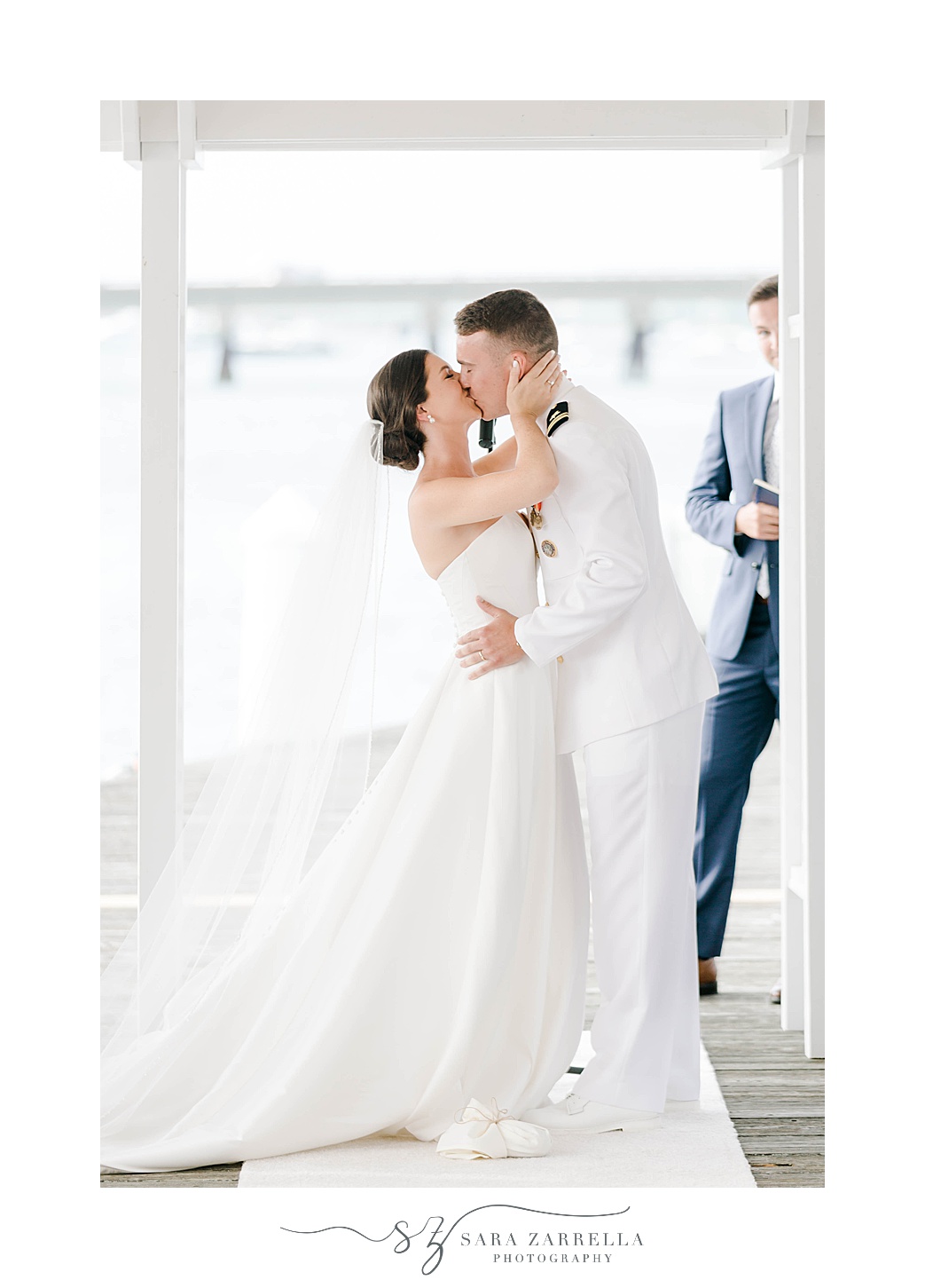 bride and groom kiss during wedding ceremony at Regatta Place