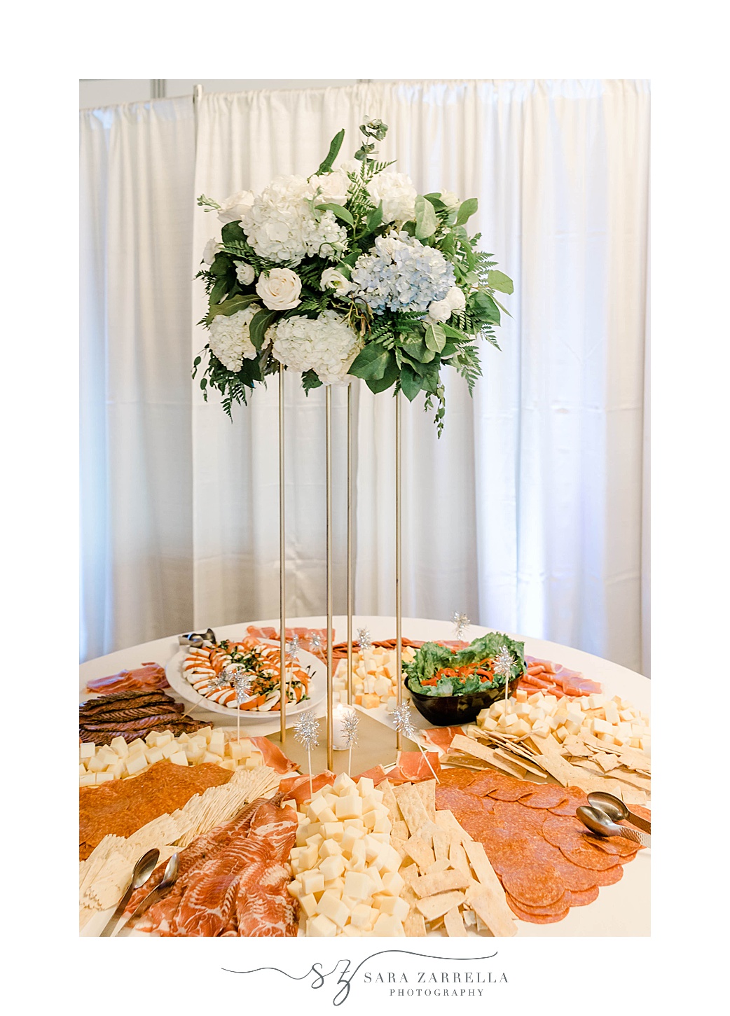 tall floral centerpiece sits on table with lunchmeat and appetizers at Kirkbrae Country Club