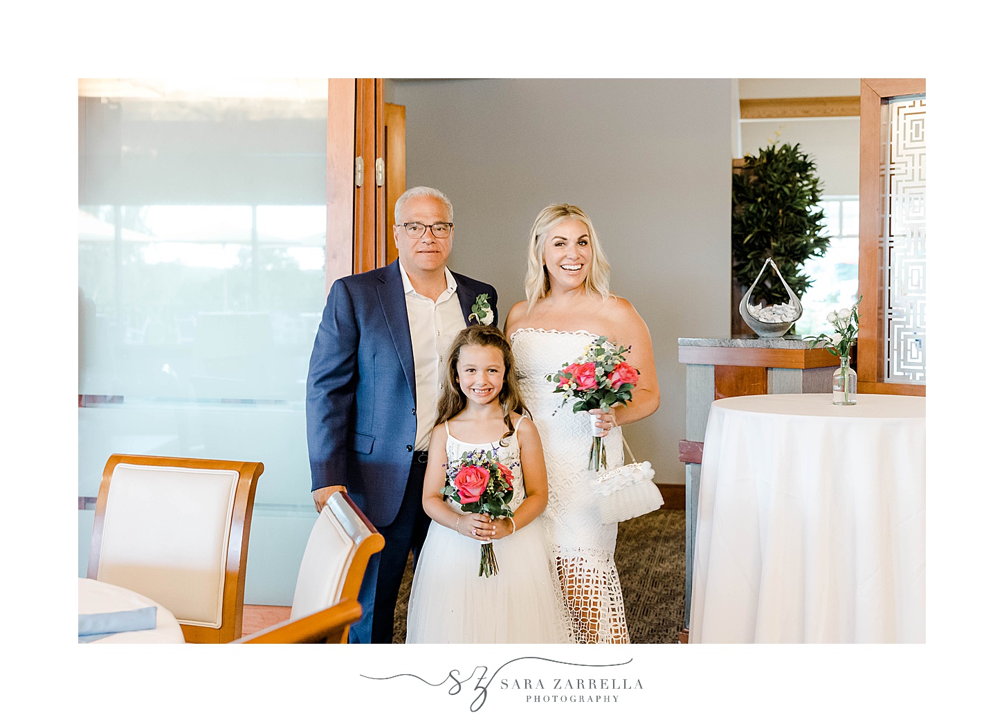 bride and groom walk into wedding reception with daughter at Kirkbrae Country Club