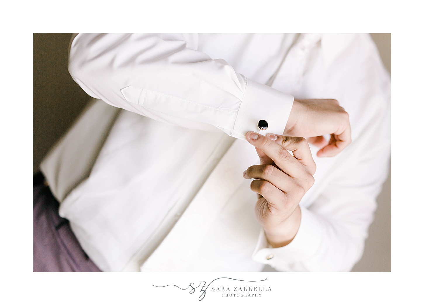 groom adjusts custom cufflinks before RI wedding day