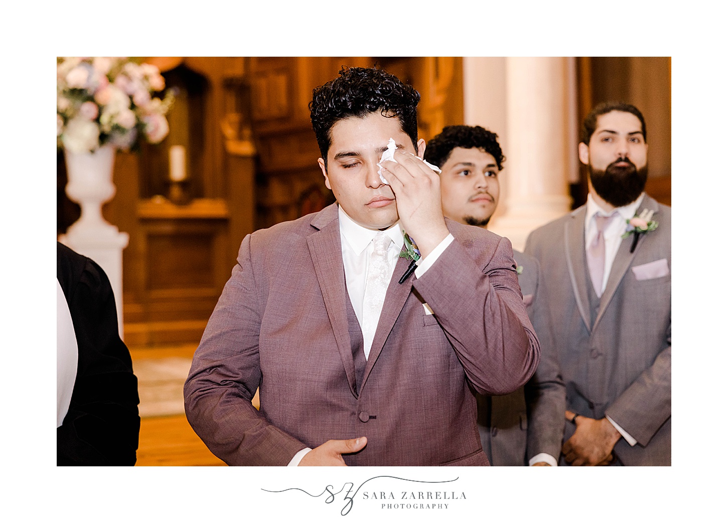 groom wipes away tears during traditional church wedding in Newport RI