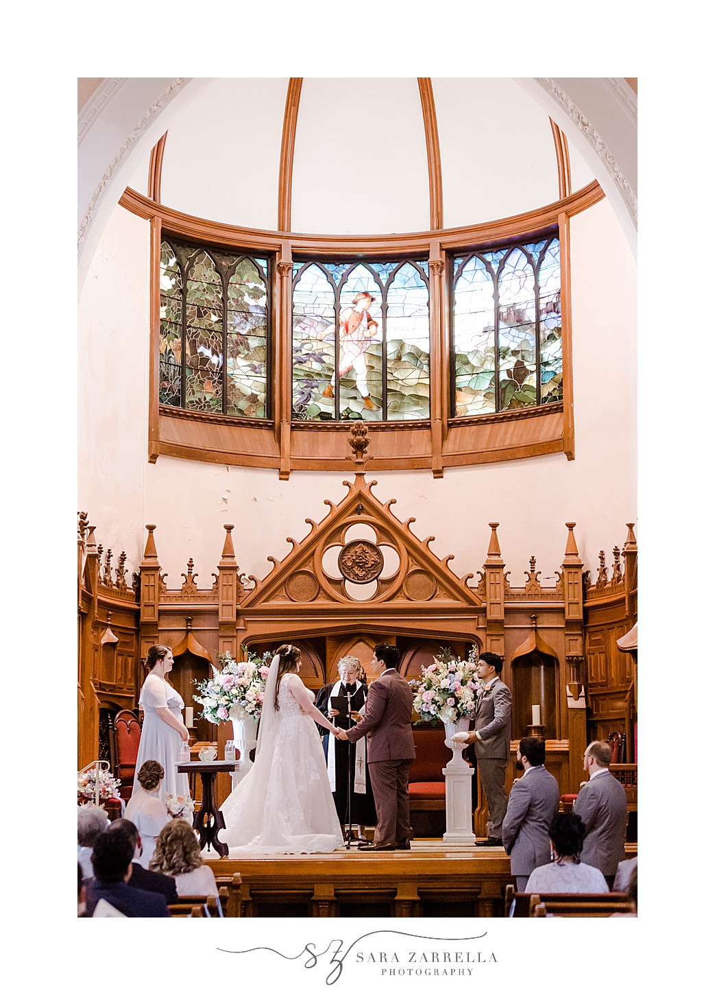 bride and groom stand at alter during traditional church wedding in Newport RI
