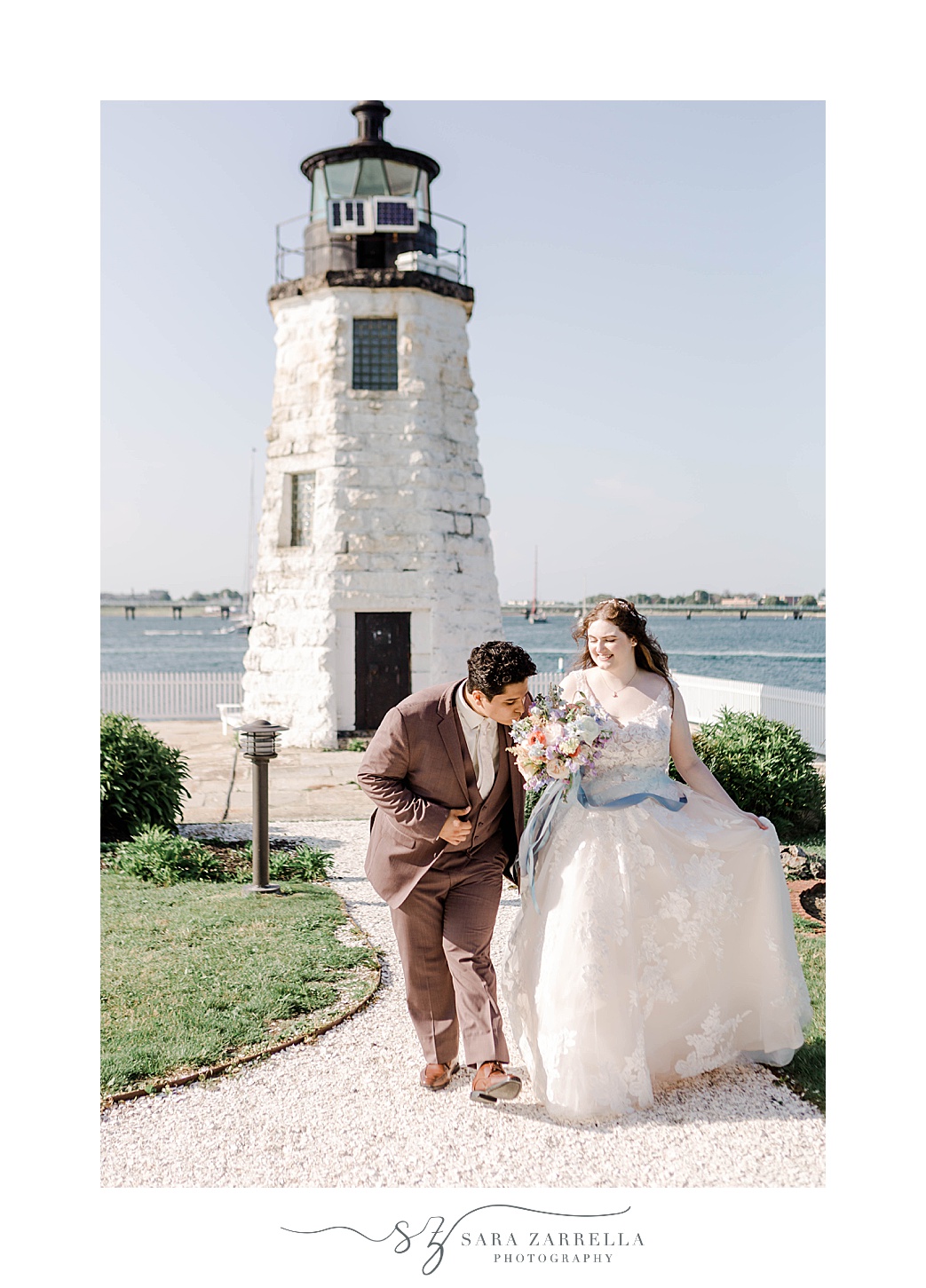 newlyweds walk away from Newport Lighthouse 