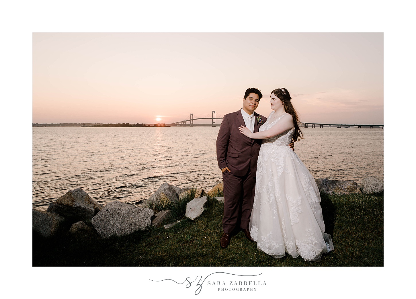 bride and groom stand on rocks at Newport Harbor Island Resort