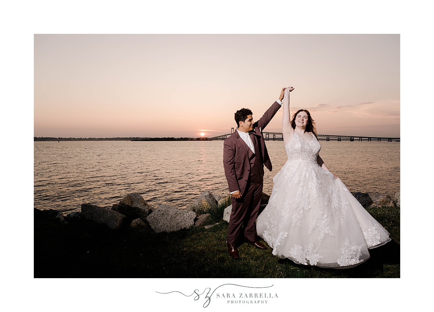 groom twirls bride under his arm at sunset outside Newport Harbor Island Resort