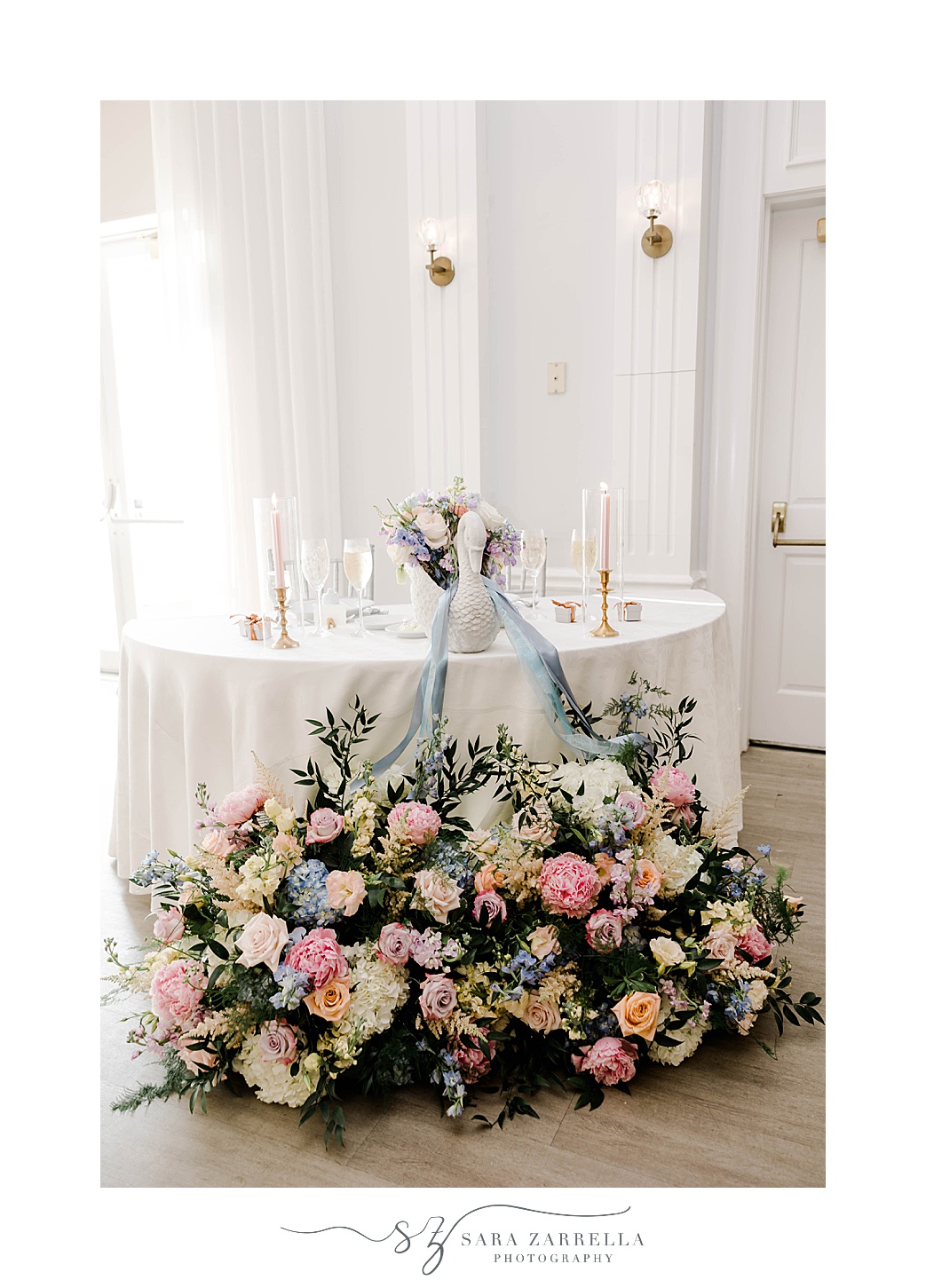 sweetheart table with floral arrangement in front at Newport Harbor Island Resort