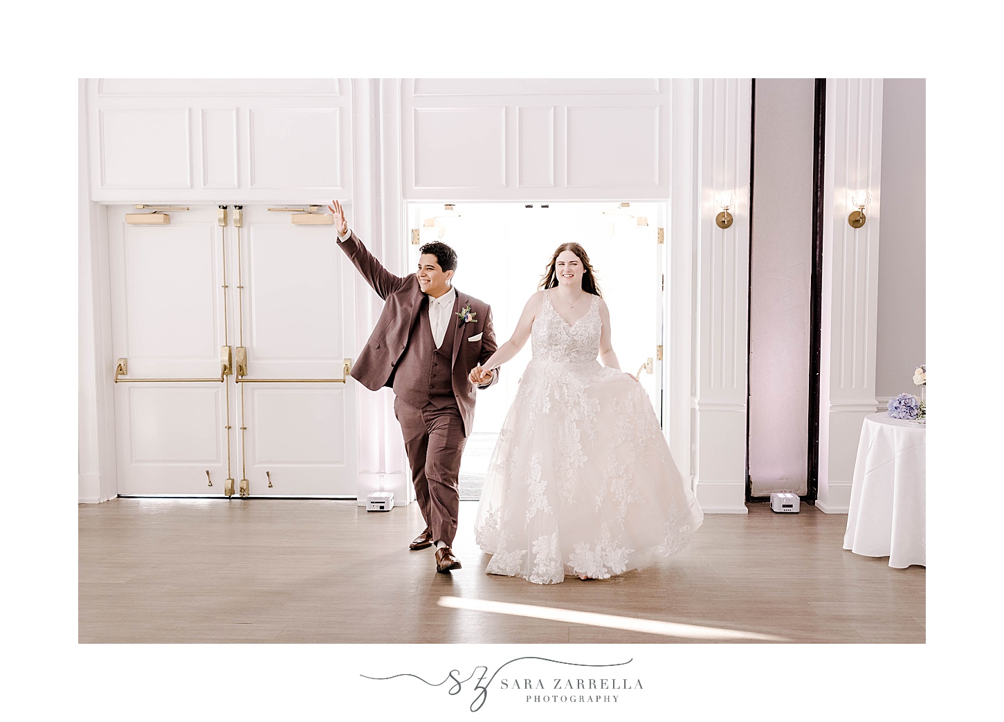 bride and groom cheer walking into wedding reception at Newport Harbor Island Resort