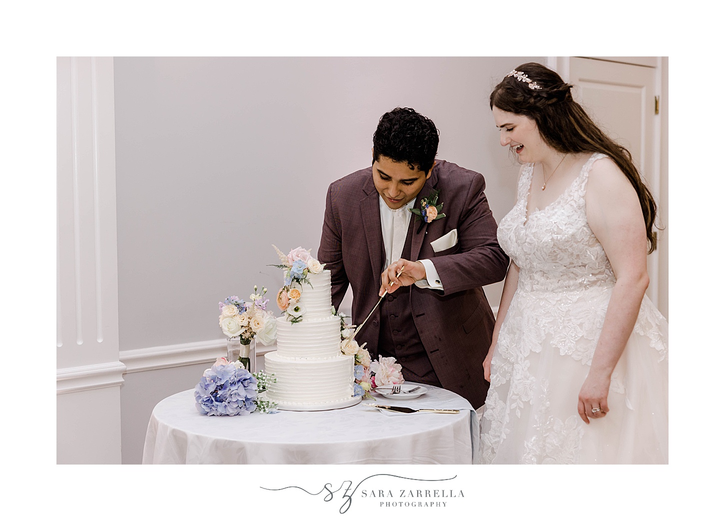 bride and groom cut wedding cake during Newport RI wedding reception 
