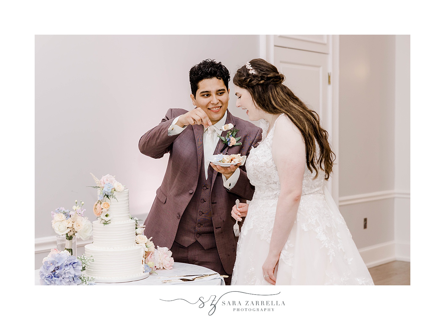 bride and groom cut wedding cake during Newport RI wedding reception 