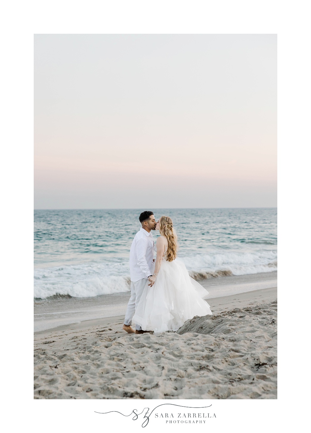 newlyweds kiss on beach at sunset at Charlestown Beach