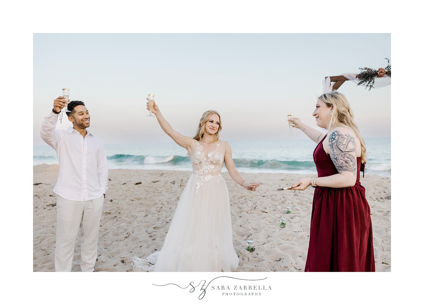 bride and groom toast with bridesmaid during beach wedding reception in Rhode Island