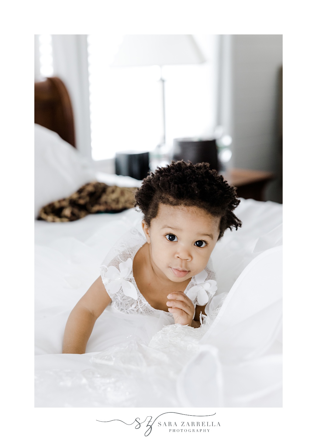 baby girl climbs on bed during wedding prep in Newport RI
