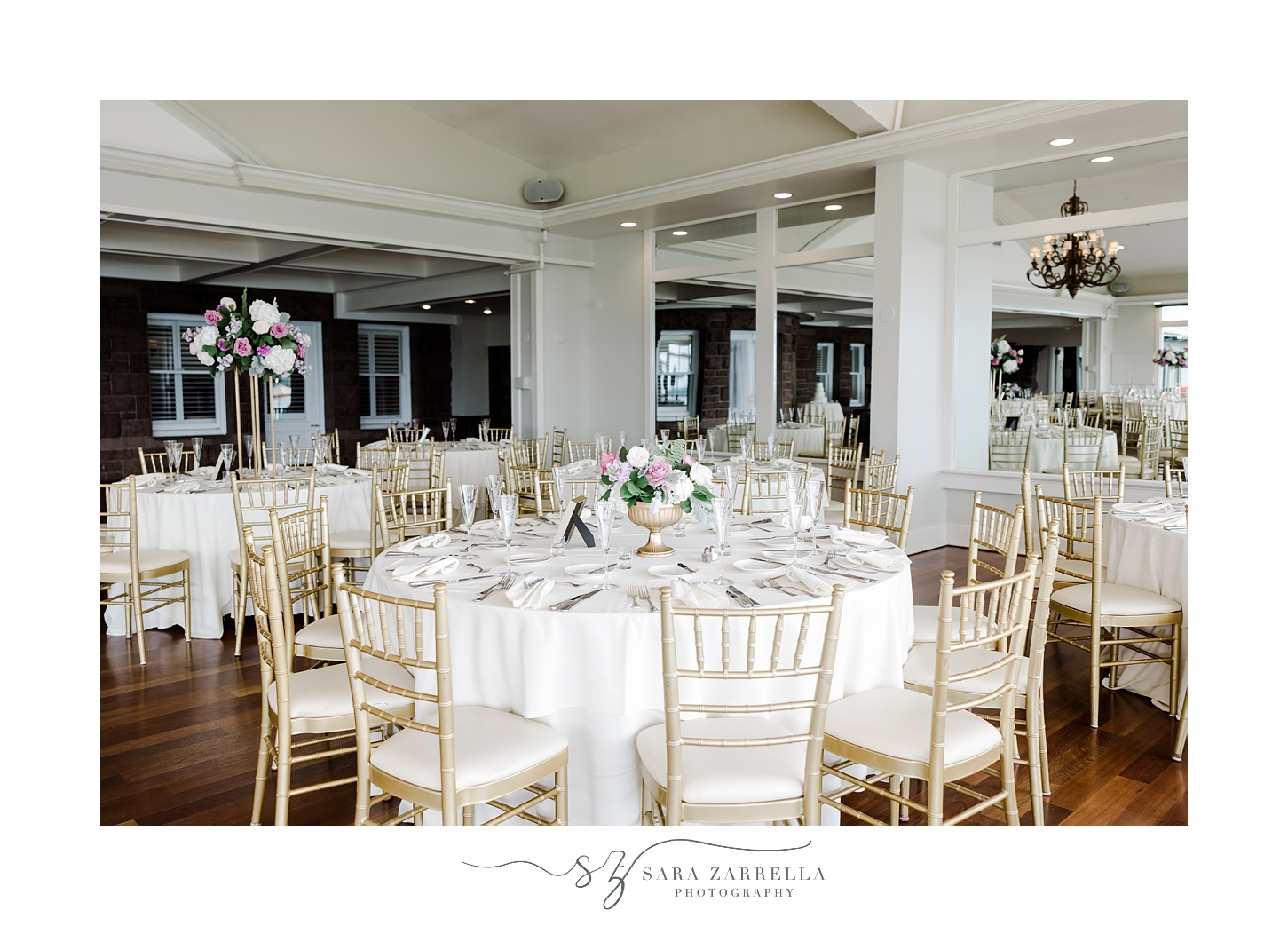wedding reception with purple and white flowers and gold chiavari chairs at OceanCliff Hotel