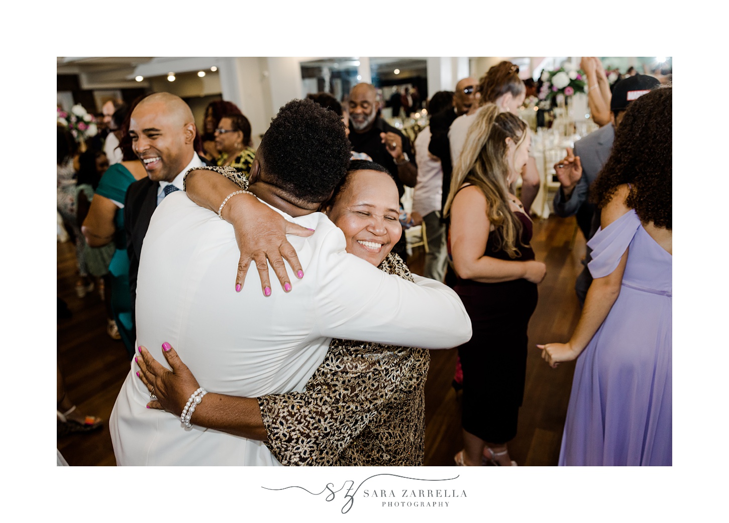 guests hug on dance floor at RI wedding reception