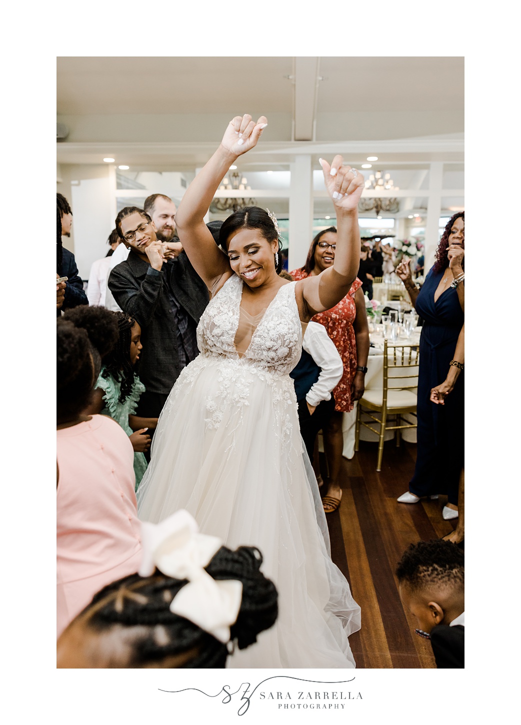 bride dances with hands in the air during RI wedding reception