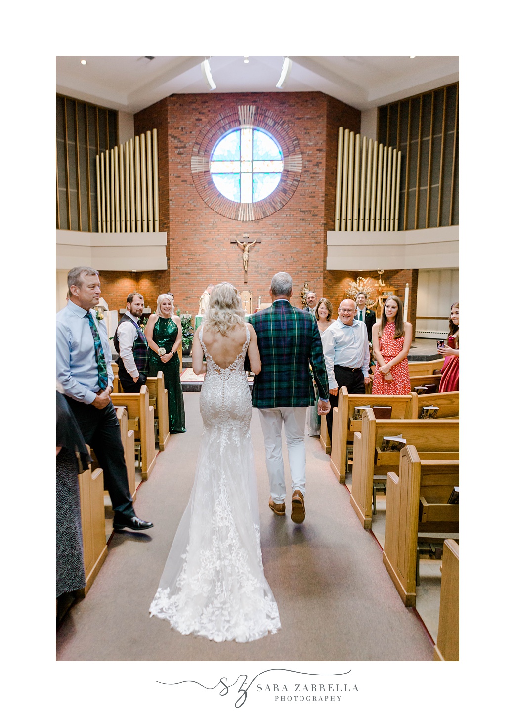 bride and father walk down aisle before traditional church wedding in Sutton MA