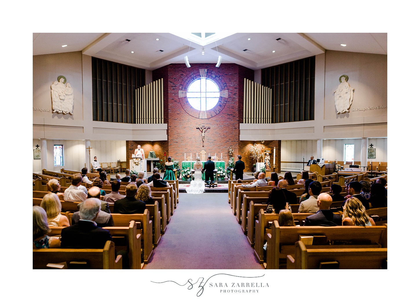 traditional church wedding in Sutton MA with bride and groom kneeling at alter 