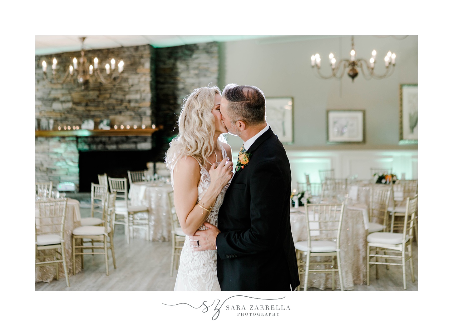 bride and groom kiss inside reception room at Pleasant Valley Country Club