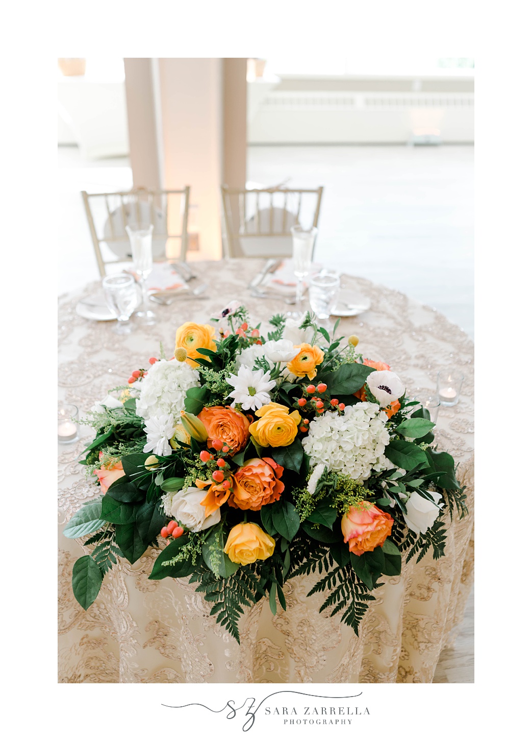 sweetheart table with orange and white flowers at Pleasant Valley Country Club