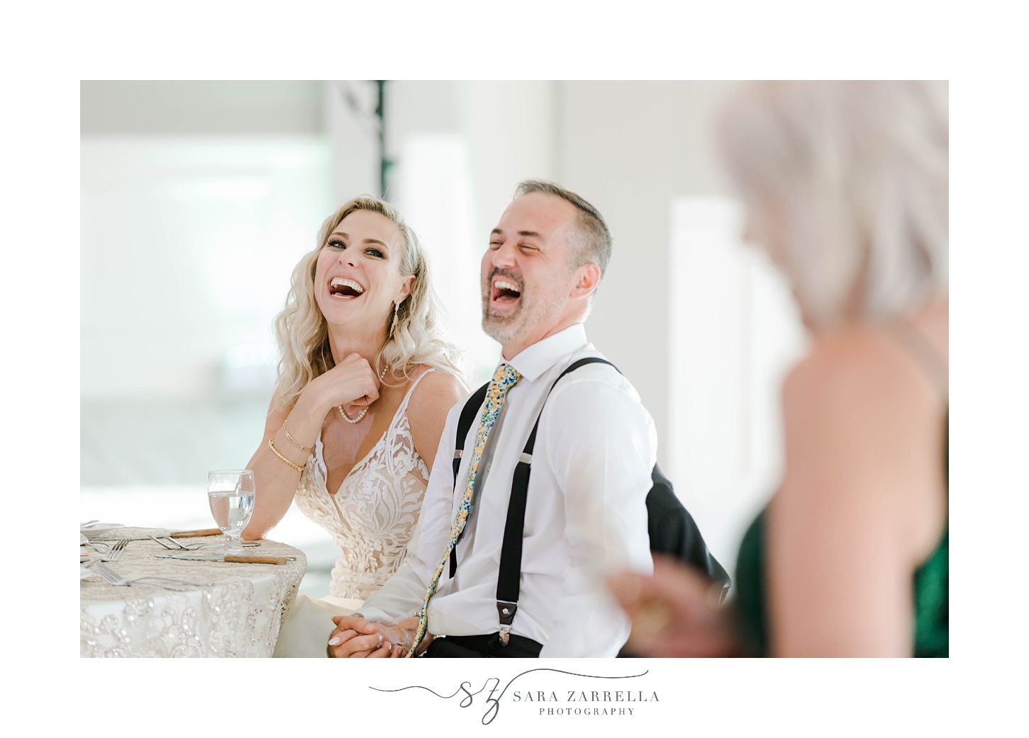 bride and groom laugh listening to toasts during Sutton MA wedding reception